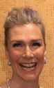 A close-up of a person smilingDescription automatically generated